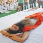 India's yoga guru Swami Ramdev, lying on stage, gets a medical check-up during his fast against corruption in the northern Indian town of Haridwar