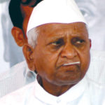 Social activist Anna Hazare holds a thermometer in his mouth