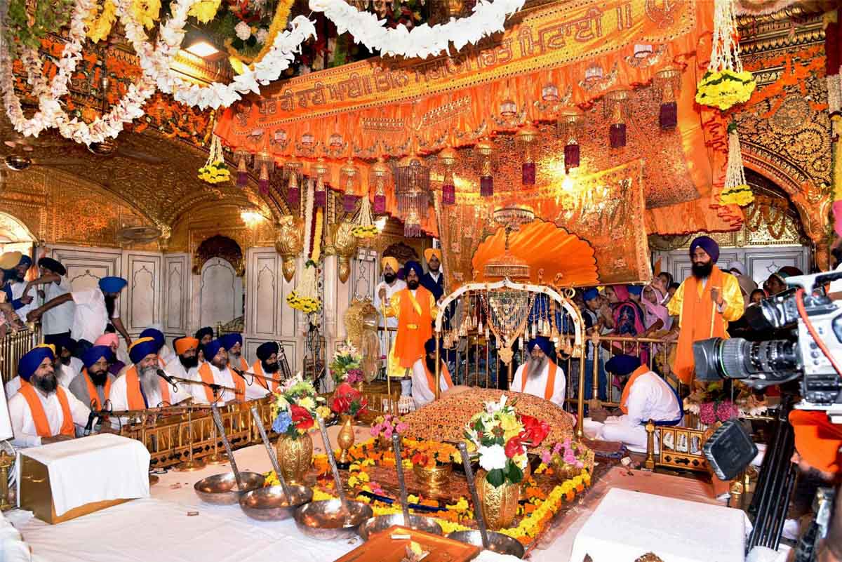 AMRITSAR: Sikh devotees pray near the Sikh holy book, Guru Granth ...