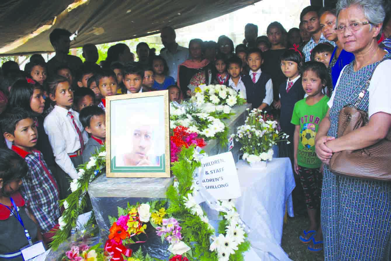 Children and staff gather arround the casket of Wanteilang Jyrwa at SOS ...