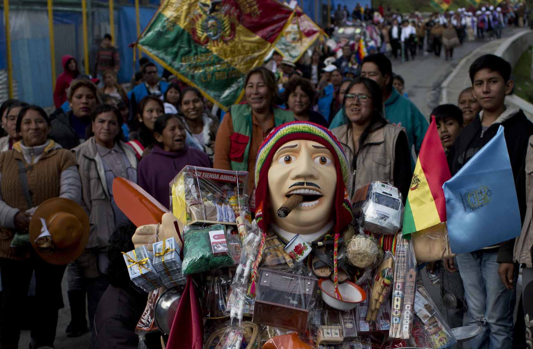 LA PAZ : People accompany the statue of Ekeko, the Bolivian god of ...