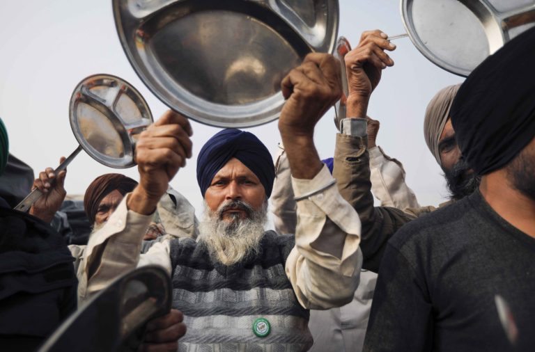 Farmers beat utensils as a protest against PM Modi’s Man ki Baat programme, during their ongoing agitation over new farm laws, at Singhu border in New Delhi, Sunday . (PTI)