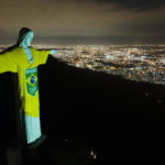 Colors of Brazilian Olympic team are projected on statue,