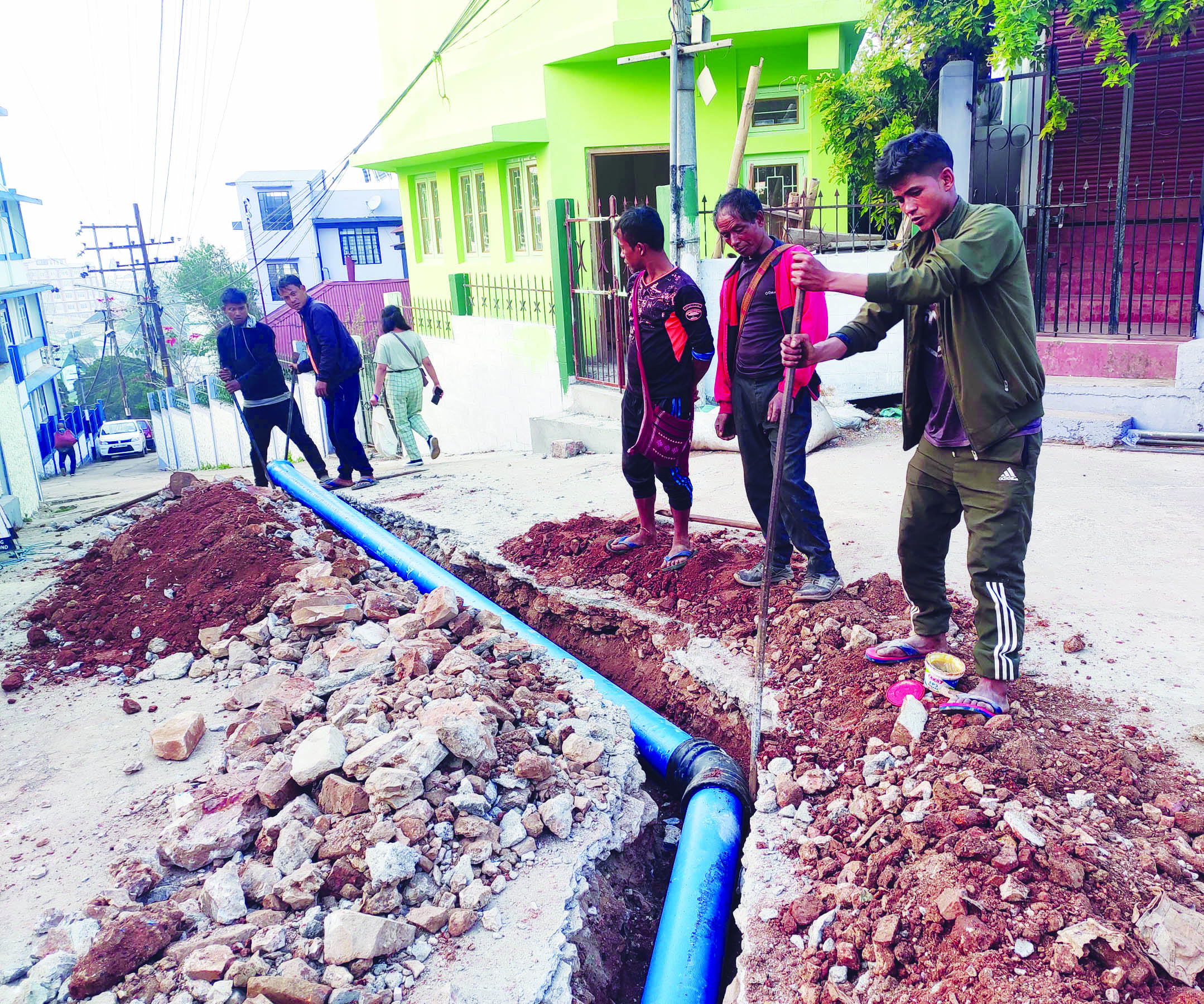 Workers lay pipes for Greater Shillong Water Supply Scheme. - The ...