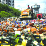 Seized liquor bottles crushed