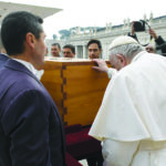 Pope Francis touches the coffin of late Pope Emeritus Benedict XVI