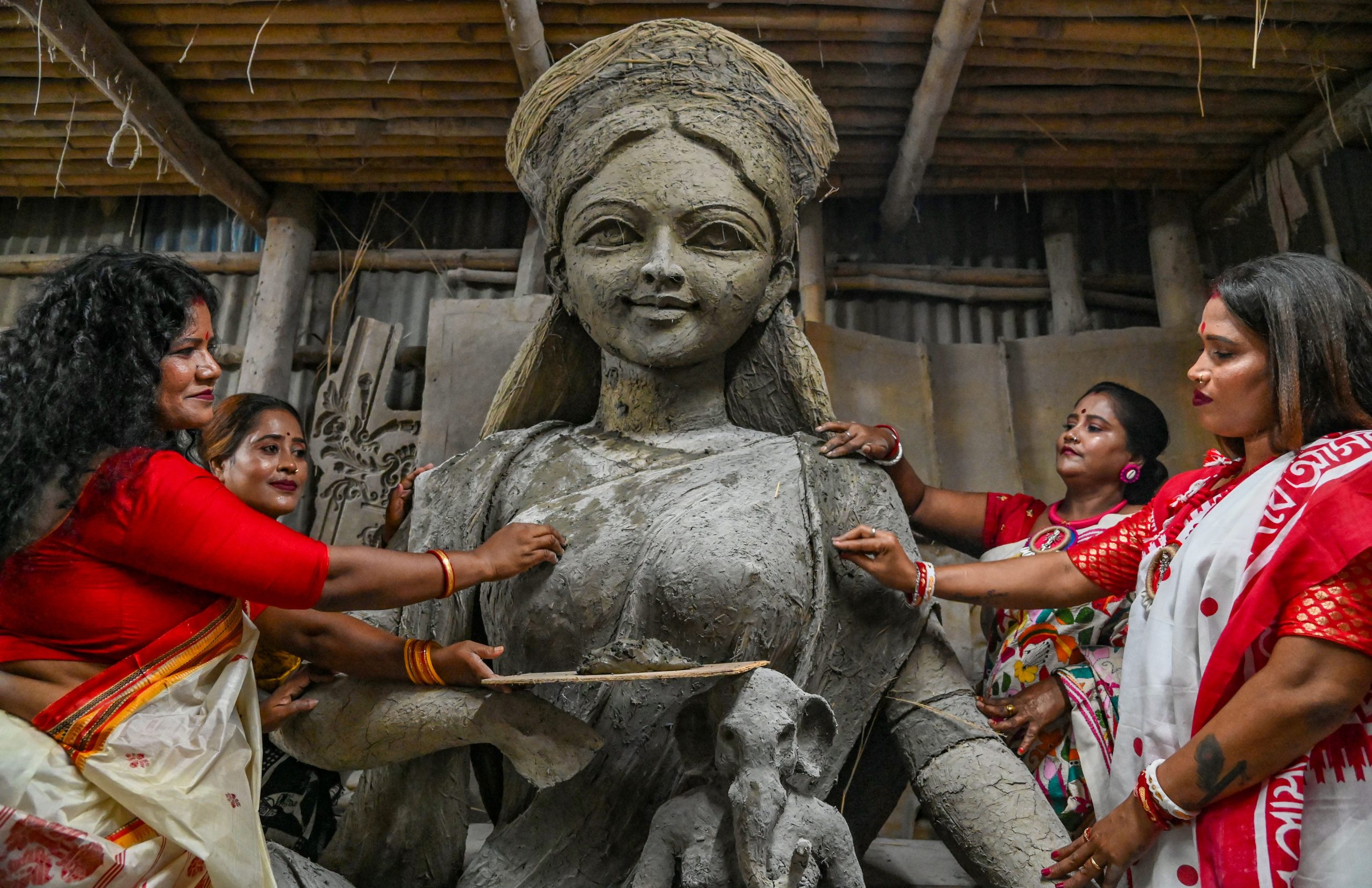 Sex Workers With An Unfinished Clay Idol Of Goddess Durga As They Unveil It For The Upcoming