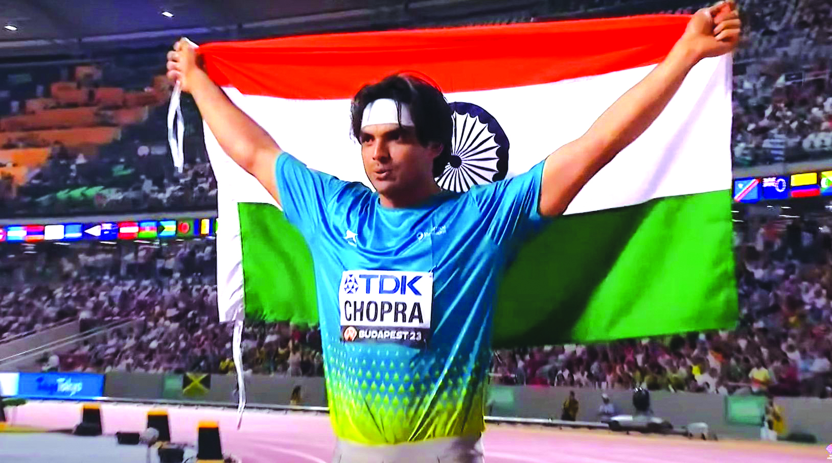 Javelin superstar Neeraj Chopra triumphantly holds the Tricolour after ...