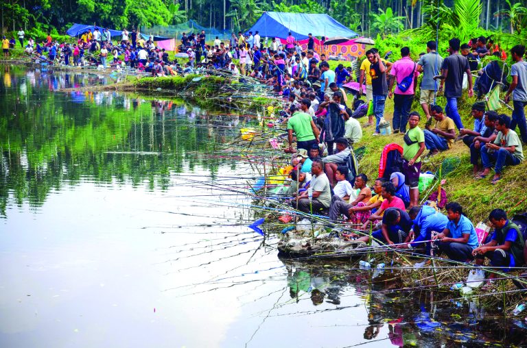 Border residents of Assam and Meghalaya take part in an angling competition along  the Assam-Meghalaya border, at Hahim in Kamrup district, on Friday. (PTI)