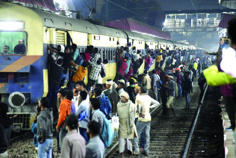 Passengers jostle to board a crowded train at Rajendra Nagar Terminal amid  rush due to the ongoing Mahakumbh Mela 2025, in Patna on Monday. (PTI)